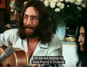 Baby Boomers with John Lennon sing give peace a chance